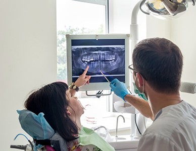 dentist showing a patient their dental X-rays 