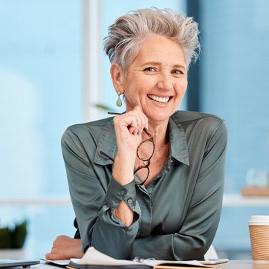 Woman smiling from her work desk