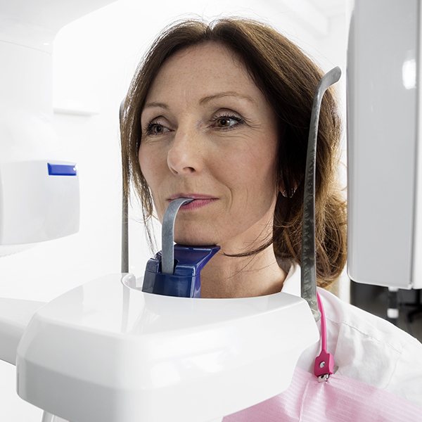 Woman receiving 3 D C T cone beam digital x ray scans