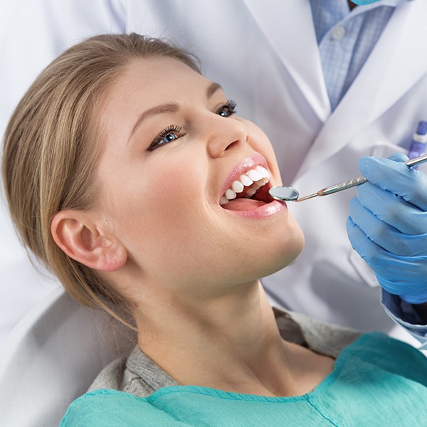 Dentist performing dental exam