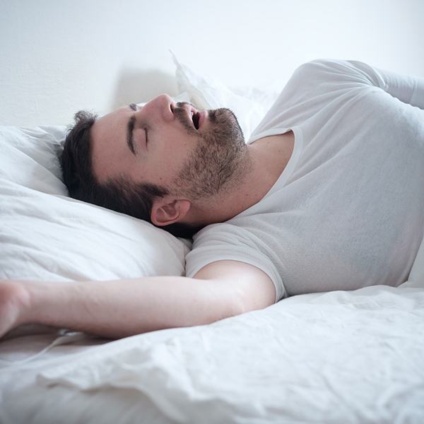 Man snoring due to sleep apnea in Hingham, MA