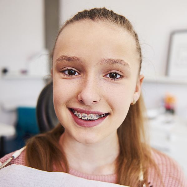Child smiling during dental checkup and teeth cleaning for kids