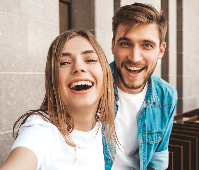 Man and woman with flawless smiles thanks to cosmetic dentistry