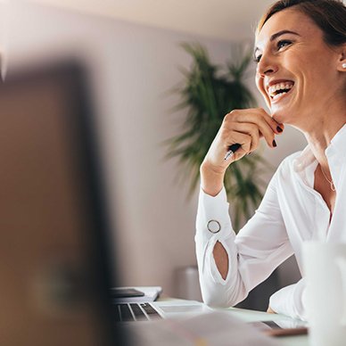 Business woman smiling confidently at her desk 