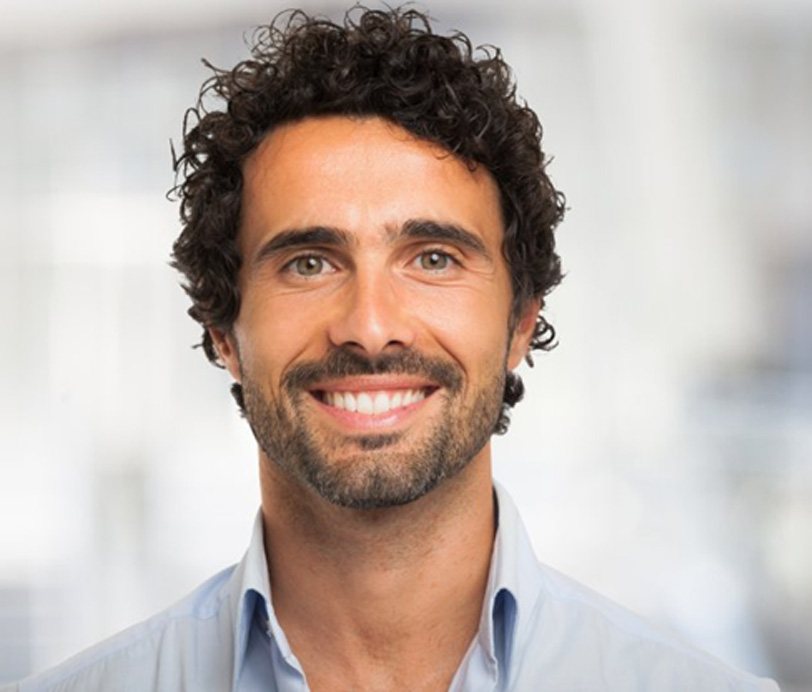 a man smiling after visiting Blue Cross Blue Shield dentist