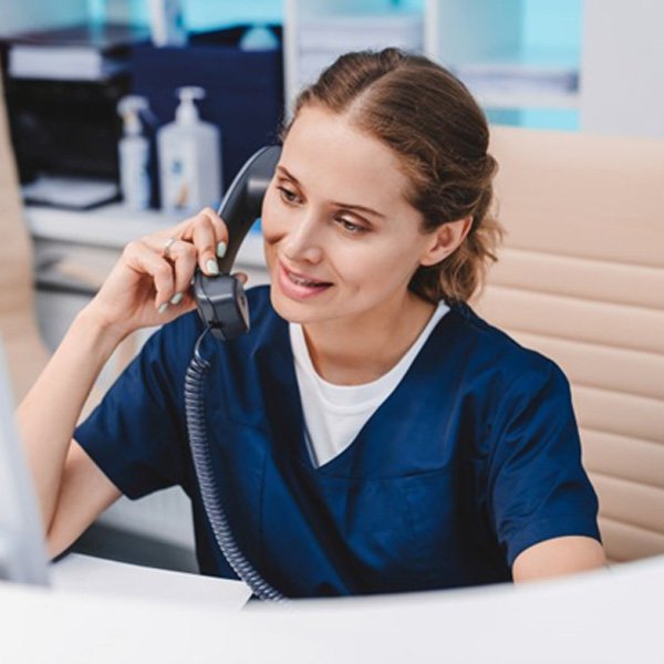 a front desk person on the phone for dental insurance