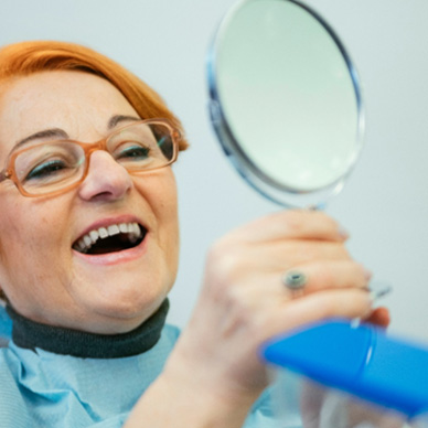 A smiling senior woman enjoying her new dentures