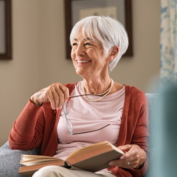 Senior woman reading a book at home 