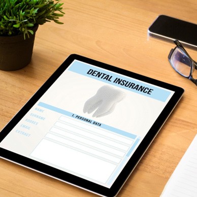 Tablet with dental insurance form on a desk