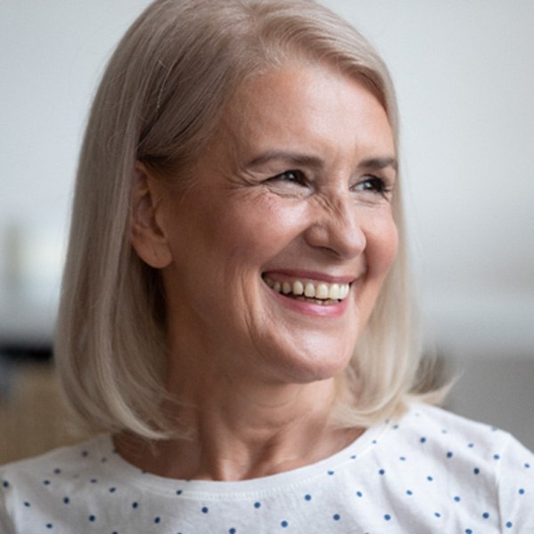 woman smiling after getting dentures 