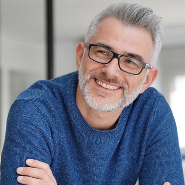 man smiling after getting dental implants In Hingham