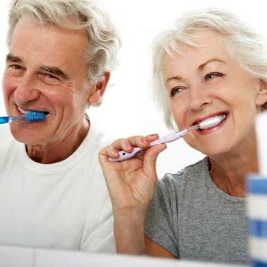 couple brushing their teeth together