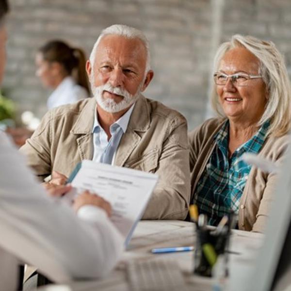 couple at a consultation for dental implants in Hingham 