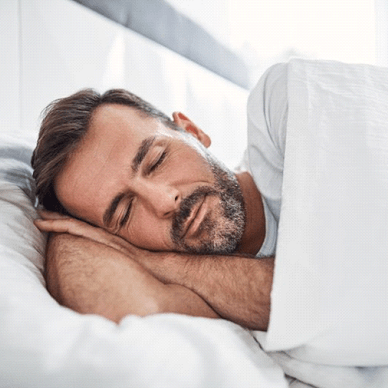 man sleeping on his side in bed