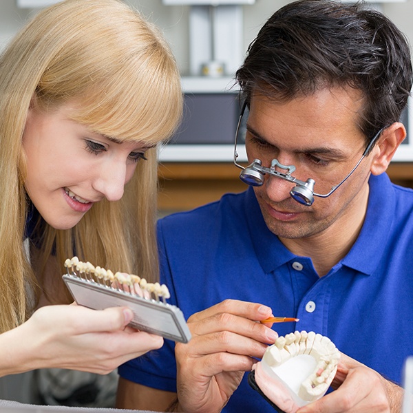 Dentist and dental patient discussing the cost of dental implants