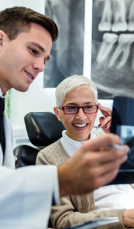 Dentist and dental patient discussing treatment plan