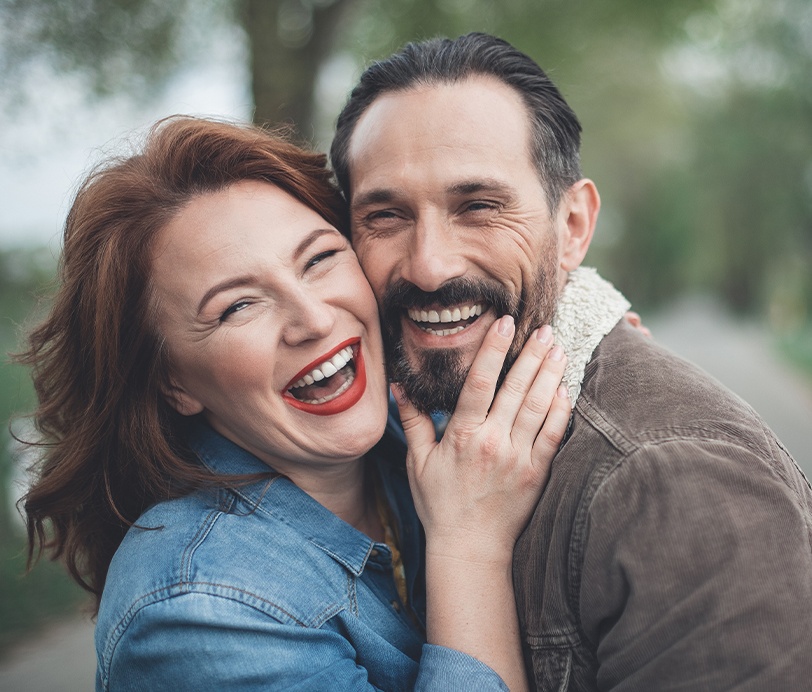 Man and woman smiling together outdoors