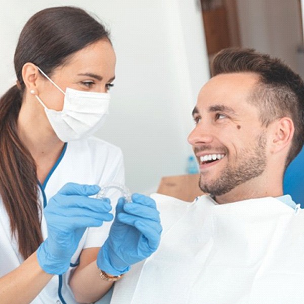 patient learning about Invisalign from his dentist