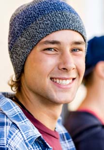 Smiling man with beanie on after restorative dentistry near Weymouth