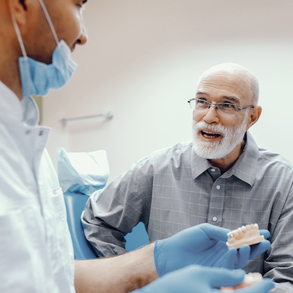 Dentist and dental patient discussing dentures