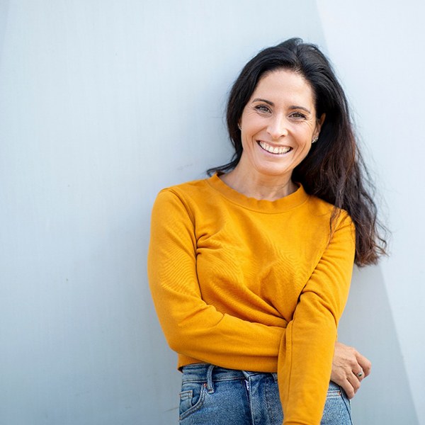 woman standing and smiling after using PerioProtect