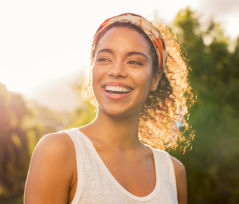 Woman smiling after visiting her sedation dentist