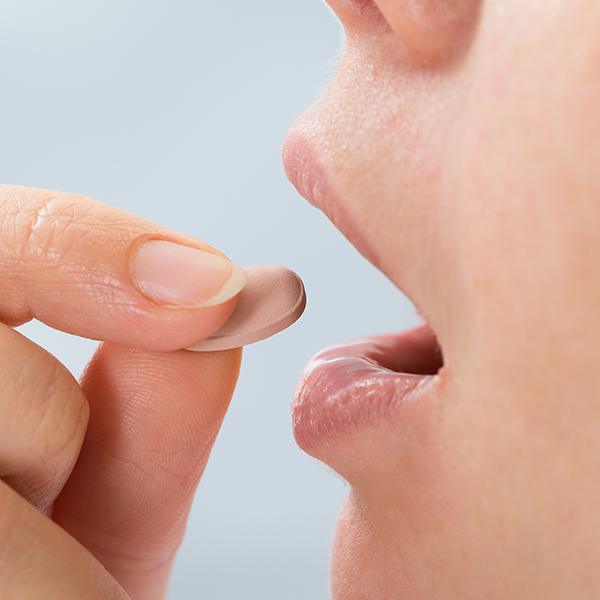 Denal patient taking an oral conscious dental sedation pill