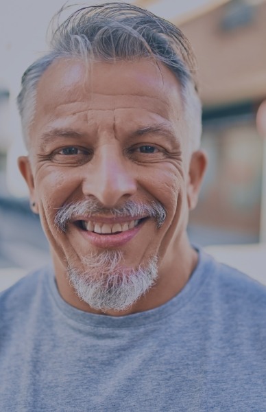 Man with full smile after replacing missing teeth