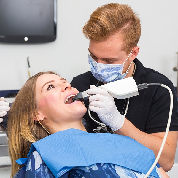 Dentist using intraoral camera to capture smile images