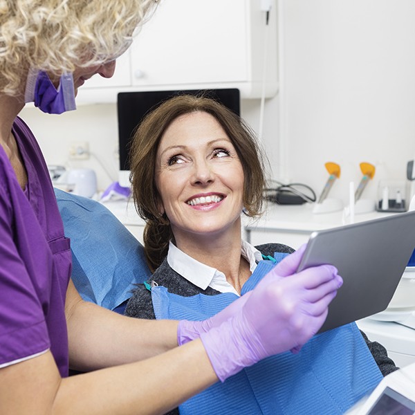 Dentist and dental patient looking at digital x rays