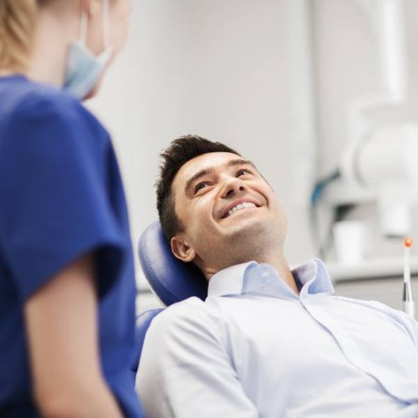 a patient visiting his dentist after wisdom tooth extractions