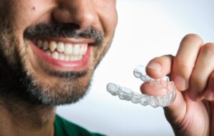 Man putting in his Invisalign tray